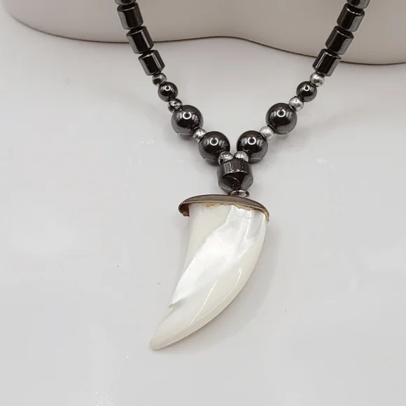 Hematite With Carved Mother Of Pearl Ivory Claw Pendant Necklace